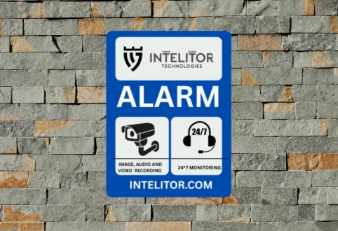 Outdoor alarm deterrent sign installed on exterior wall to warn intruders